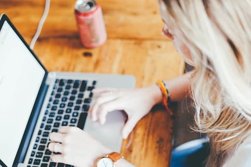 A woman is working on her laptop