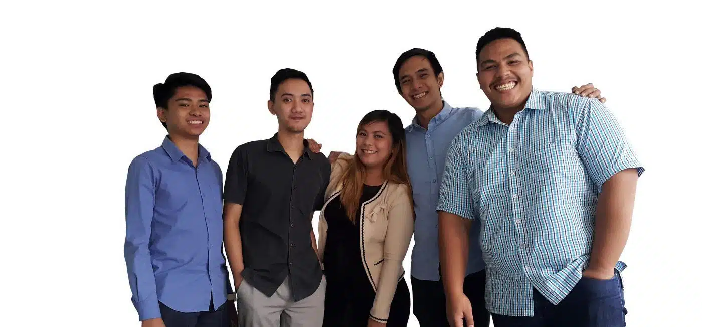 Five colleagues standing together and smiling at the camera