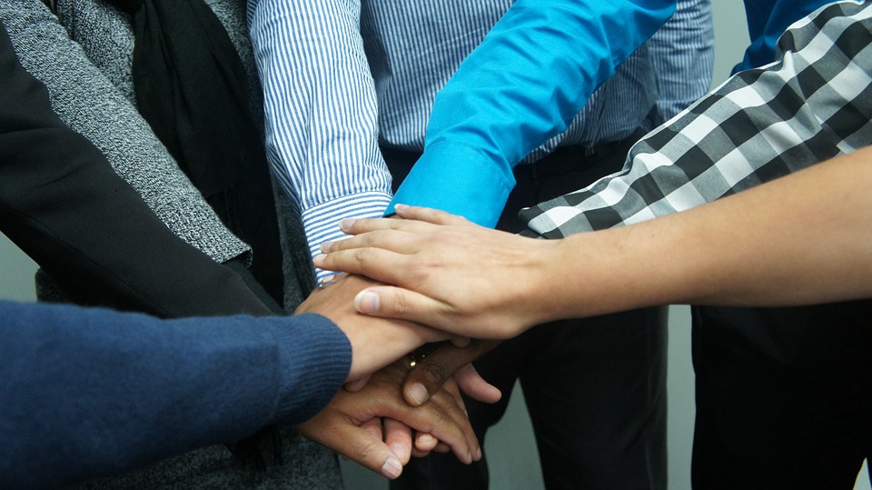 The image depicts collaboration and teamwork.
