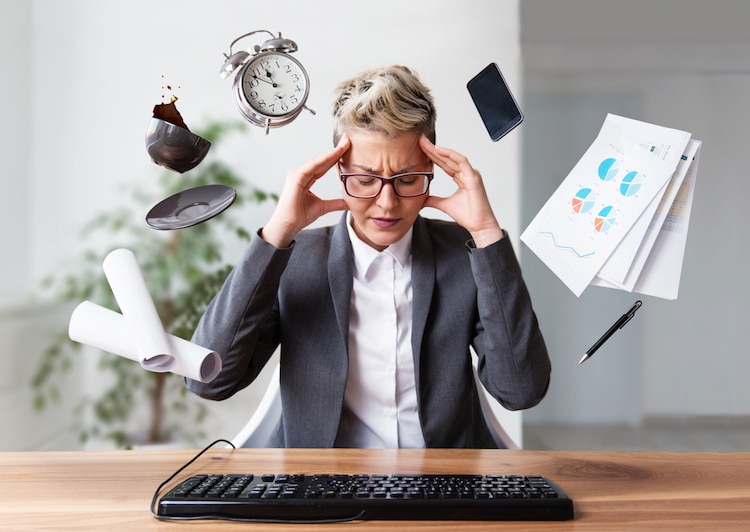 Businesswoman working on a laptop, overworking, under pressure