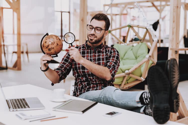 businessman examining a globe