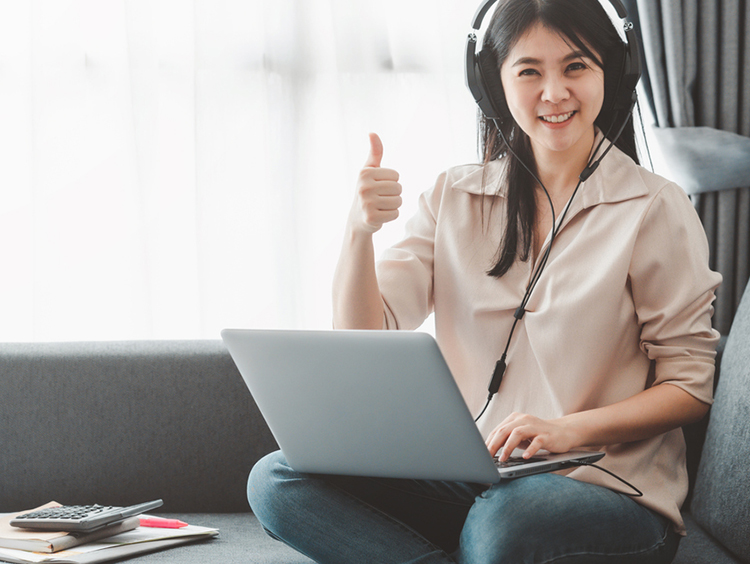 Asian executive assistant working at home showing thumb up