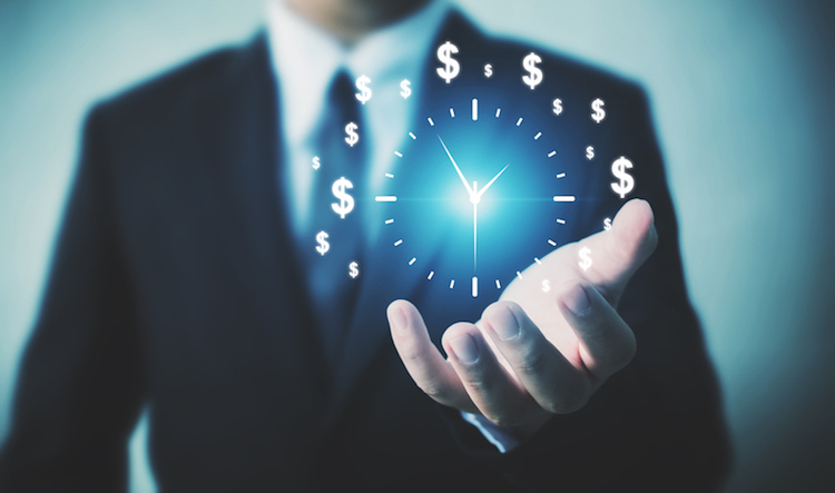 Businessman holding sign clock.