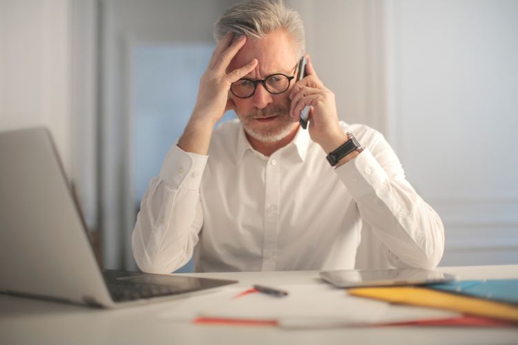 businessman talking on the phone, looking upset