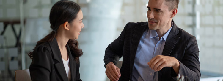 female employee talking to male employer