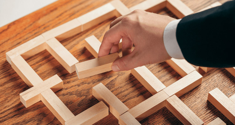 a hand connecting rectangular pieces of wood together