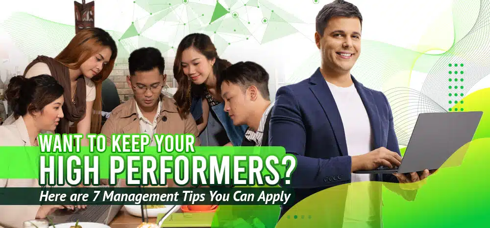 A group of people, with a man holding his laptop.